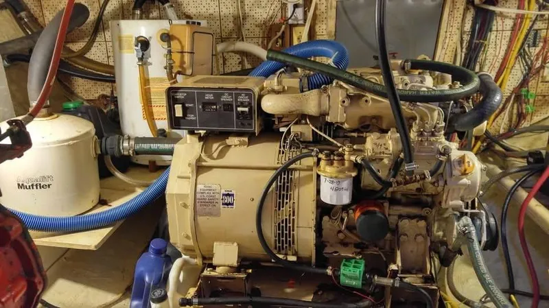 Slide: The Image of Engine room of a 1979 Universal Marine 41, featuring various mechanical components and hoses. - 18