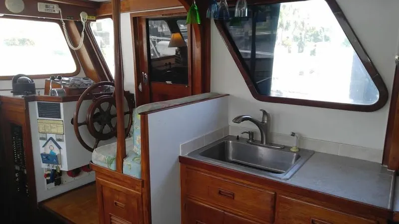Slide: The Image of 1979 Universal Marine 41 boat interior with steering wheel and kitchen sink. - 6