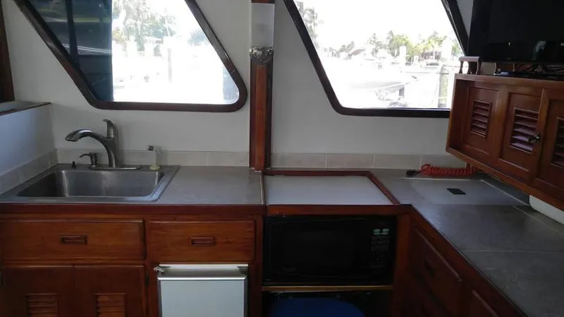 Slide: The Image of 1979 Universal Marine 41 boat kitchen with wooden cabinets and modern appliances. - 8