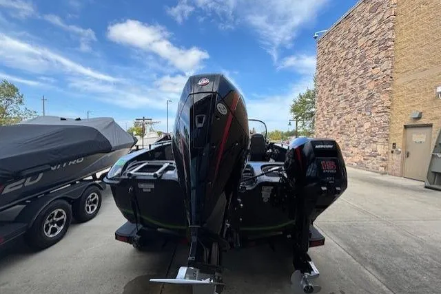 Slide: The Image of 2024 Nitro ZV19 Pro boat with Mercury engine, parked outdoors under blue sky. - 48