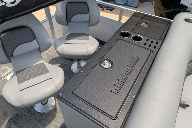 Slide: The Image of 2025 Ranger Reata 223FC boat interior with seating and console featuring cup holders. - 9