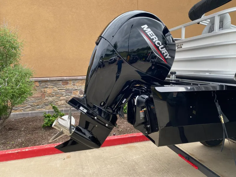 Slide: The Image of 2025 Ranger Reata 223FC boat with Mercury outboard motor, parked on concrete. - 5