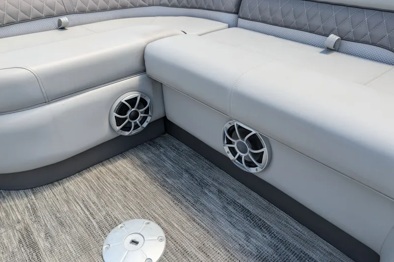 Slide: The Image of 2025 Ranger Reata 223FC boat interior with cushioned seating and built-in speakers. - 8
