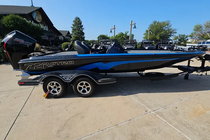 Slide: The Image of 2025 Nitro Z21 XL boat with trailer, parked outdoors on a sunny day. - 4