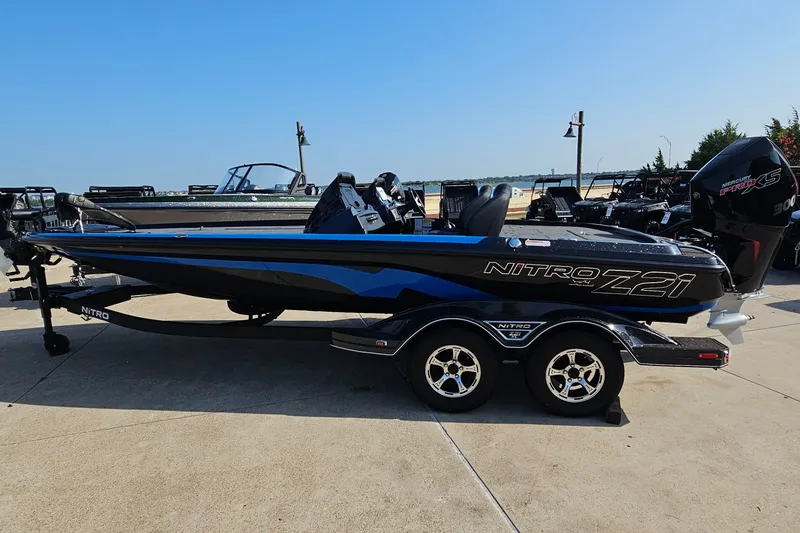 The Image of 2025 Nitro Z21 XL boat with sleek design on a trailer, parked outdoors. - 0