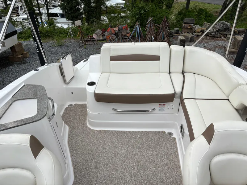 Slide: The Image of 2014 Chaparral 224 Sunesta boat interior with white and beige seating. - 16