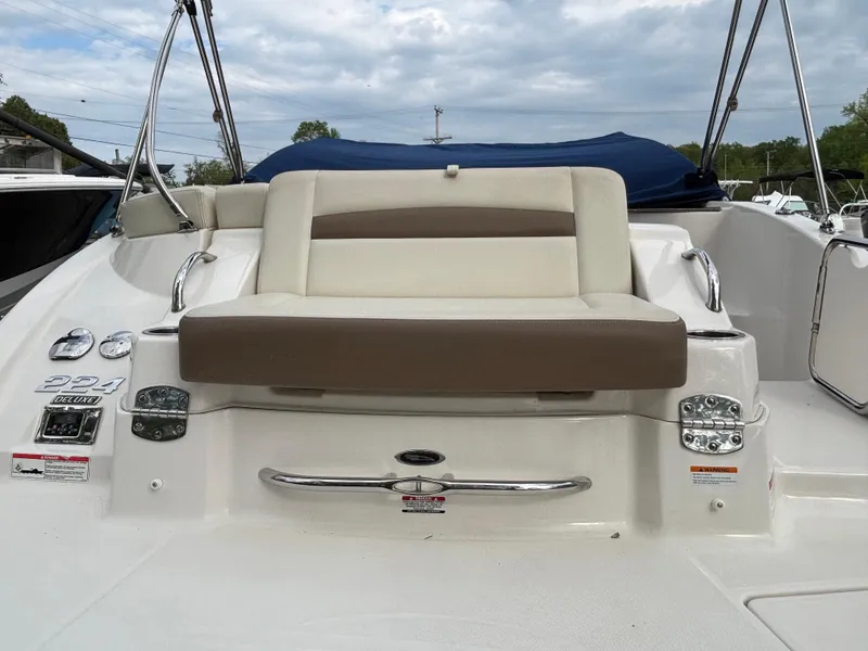 Slide: The Image of 2014 Chaparral 224 Sunesta boat with cushioned seating and sleek design. - 20