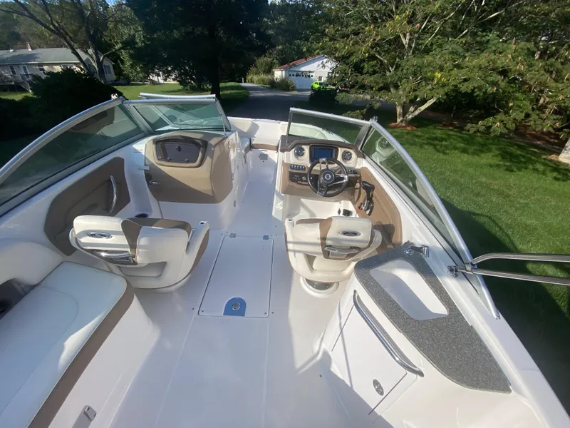 Slide: The Image of 2014 Chaparral 224 Sunesta boat interior with seating and steering console. - 23