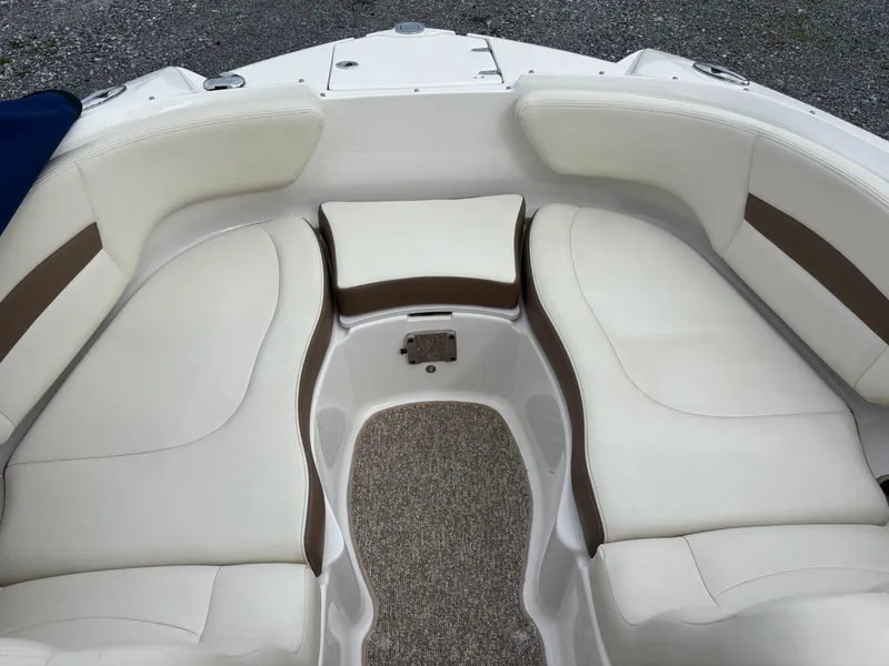 Slide: The Image of 2014 Chaparral 224 Sunesta boat interior with white and brown seating. - 32