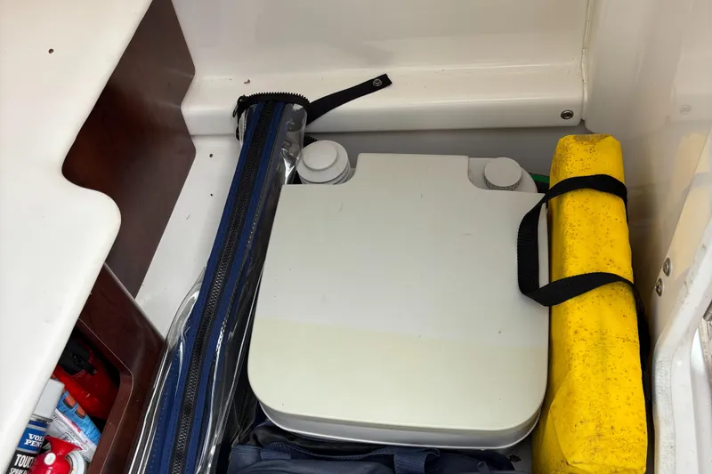 Slide: The Image of 2014 Chaparral 224 Sunesta storage compartment with portable toilet and safety equipment. - 41