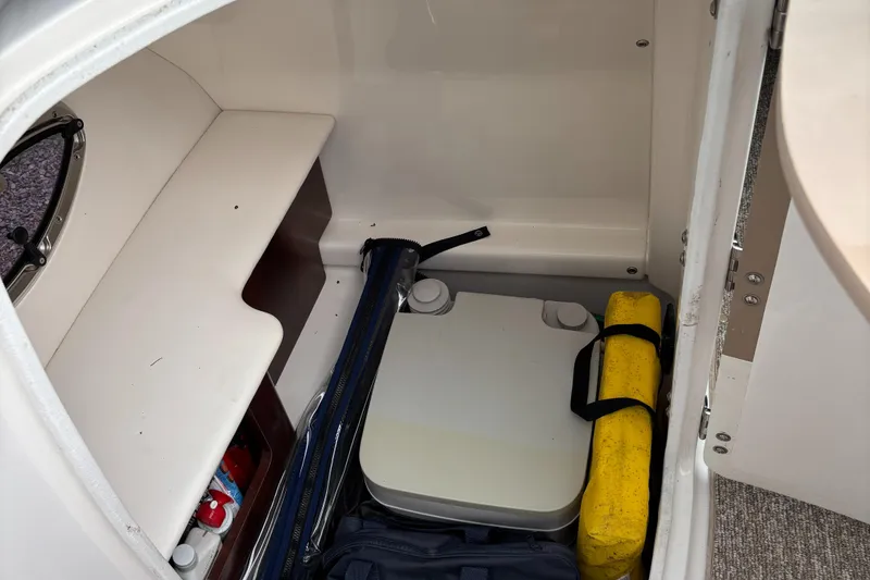 Slide: The Image of 2014 Chaparral 224 Sunesta storage compartment with equipment and supplies. - 42