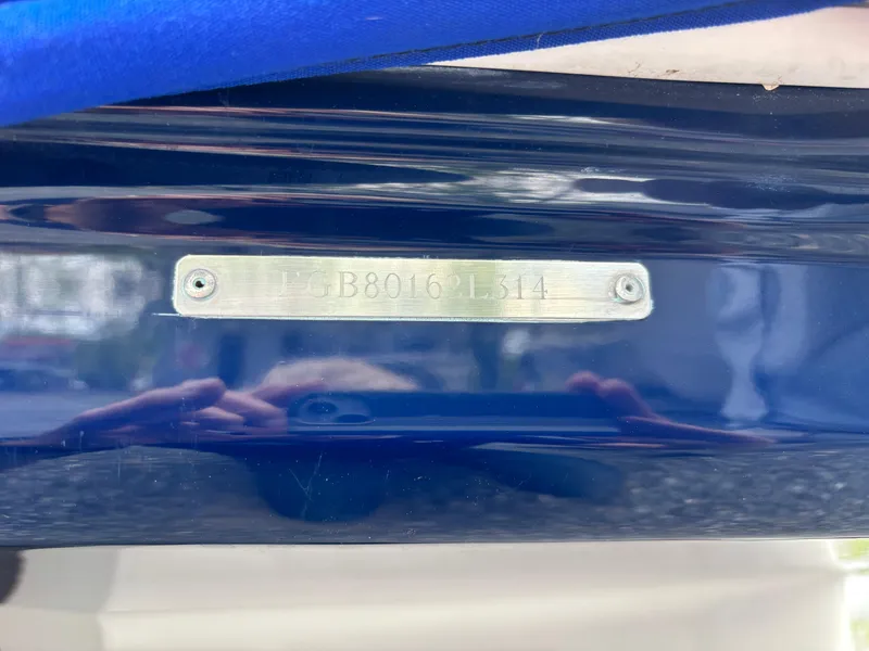 Slide: The Image of 2014 Chaparral 224 Sunesta boat identification plate on blue hull. - 7