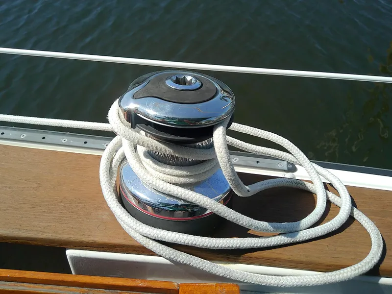 Slide: The Image of Winch with rope on 2017 Com-Pac 27/3 sailboat, docked on calm water. - 18