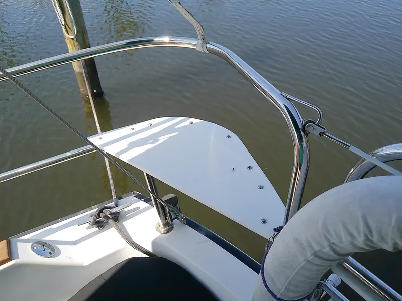 Slide: The Image of Sailboat deck detail of 2017 Com-Pac 27/3, featuring stainless steel railings and water view. - 26