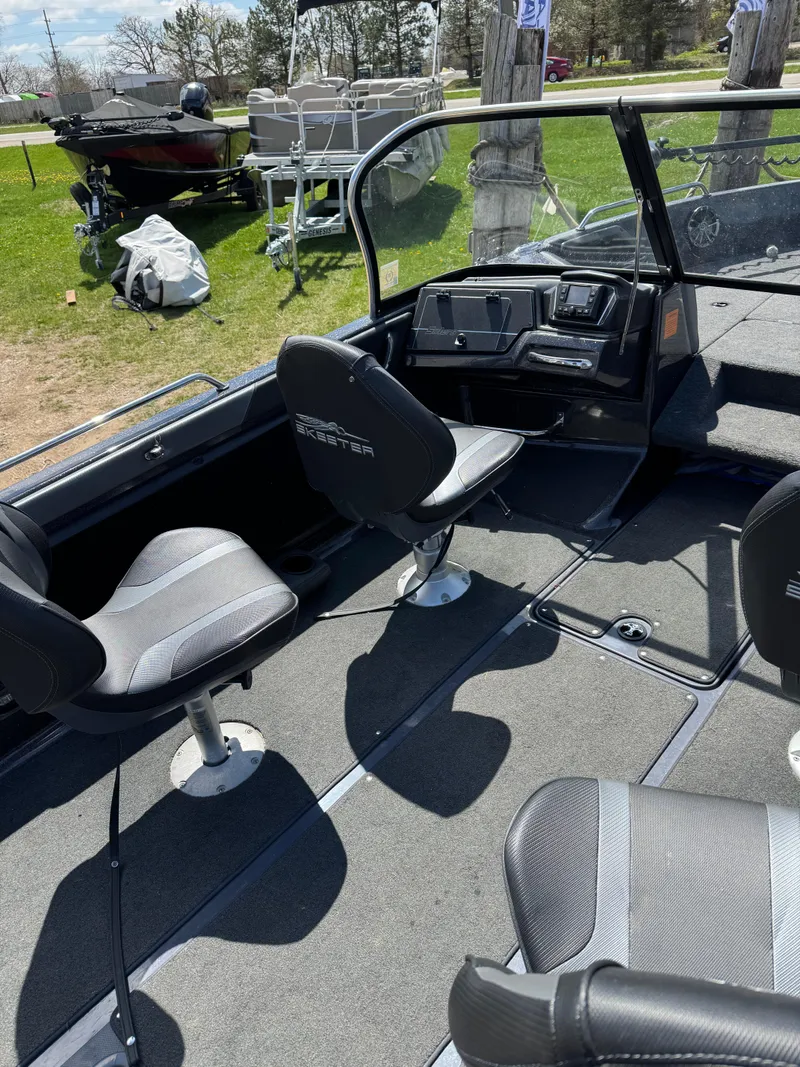 Slide: The Image of 2022 Skeeter Solera 205 boat interior with seating and dashboard, parked on grass. - 10