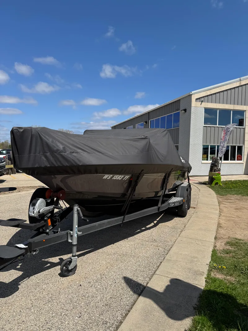 Slide: The Image of 2022 Skeeter Solera 205 boat with Yamaha outboard motor under a partly cloudy sky. - 2