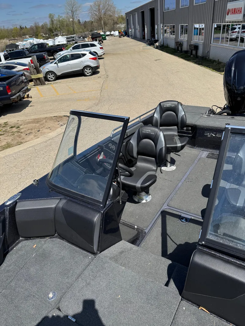 Slide: The Image of 2022 Skeeter Solera 205 boat with dual seats, parked outdoors near a dealership. - 21