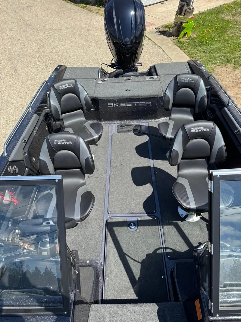 Slide: The Image of 2022 Skeeter Solera 205 boat interior with seating and motor, viewed from above. - 22