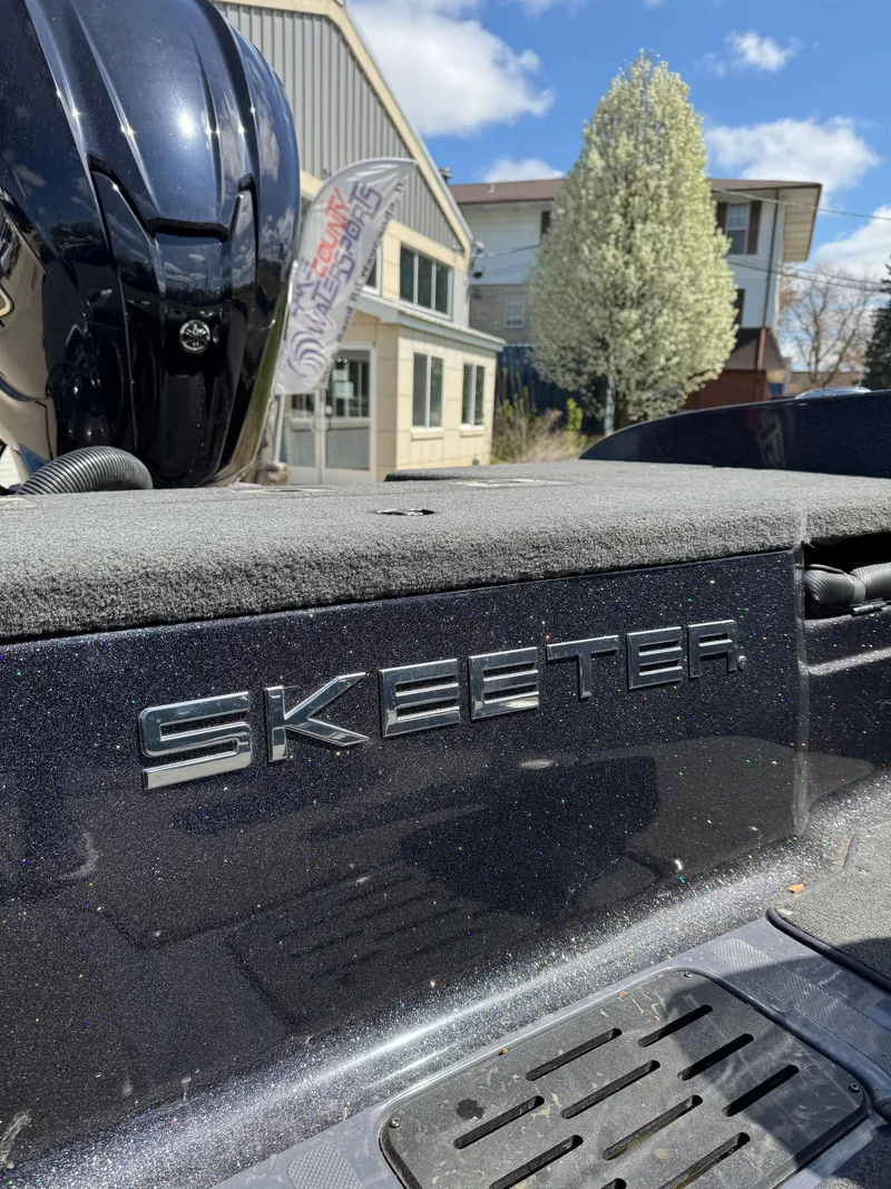 Slide: The Image of 2022 Skeeter Solera 205 boat exterior with logo, outdoor setting, clear sky. - 24