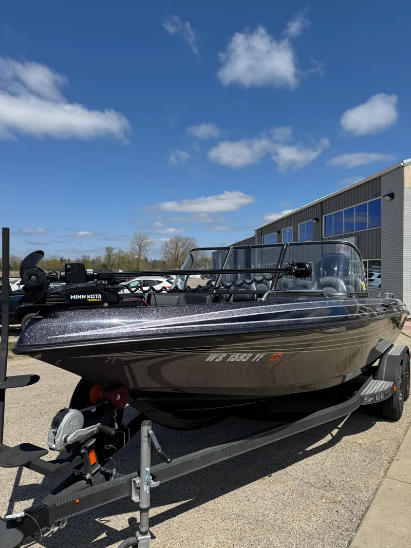 Slide: The Image of 2022 Skeeter Solera 205 boat on trailer, parked outdoors under blue sky. - 26