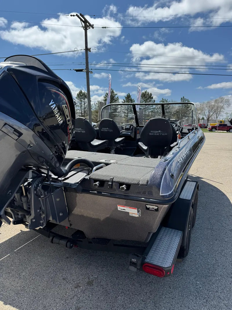 Slide: The Image of 2022 Skeeter Solera 205 boat with Yamaha engine, parked outdoors under a blue sky. - 6
