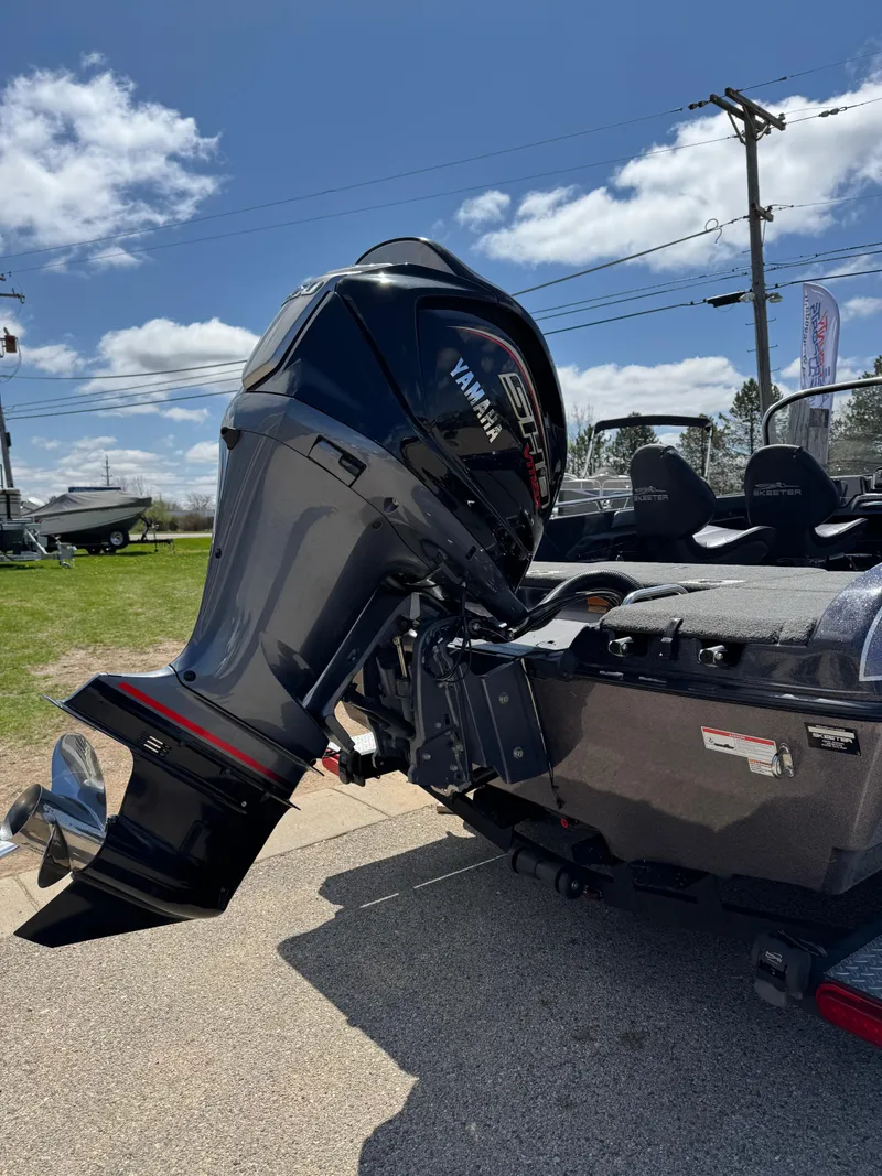 Slide: The Image of 2022 Skeeter Solera 205 boat with Yamaha outboard motor, parked outdoors under a blue sky. - 7