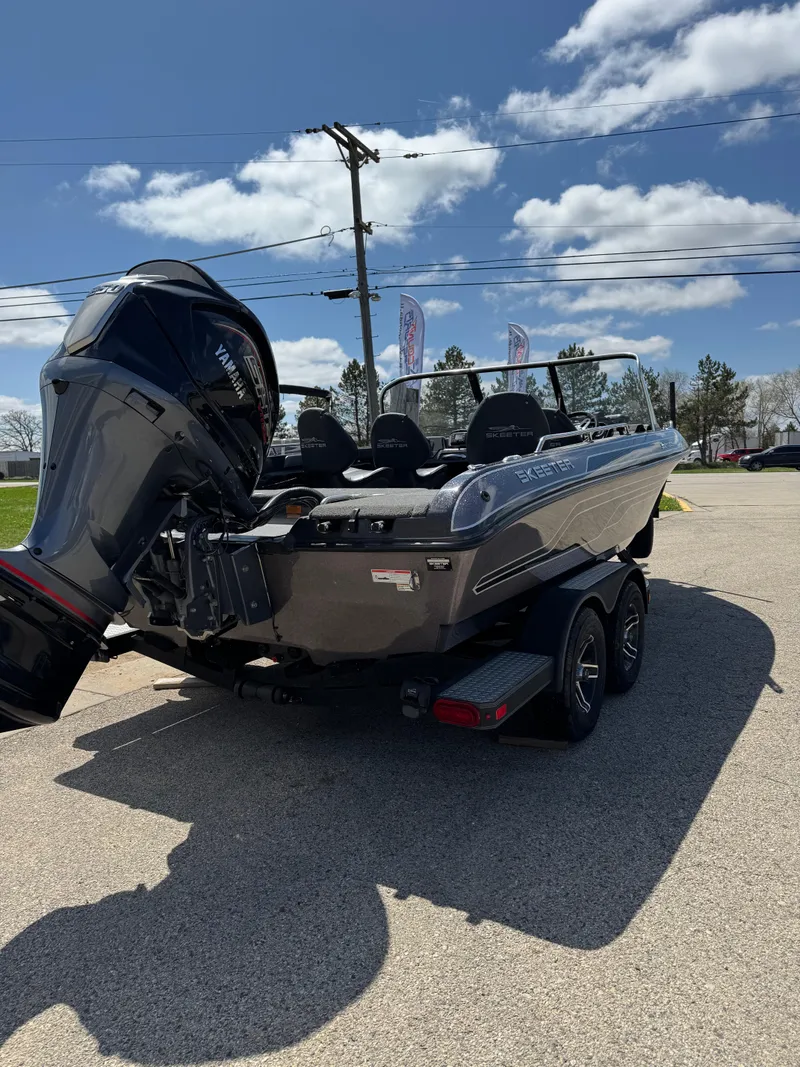Slide: The Image of 2022 Skeeter Solera 205 boat with powerful outboard motor, parked on a sunny day. - 8