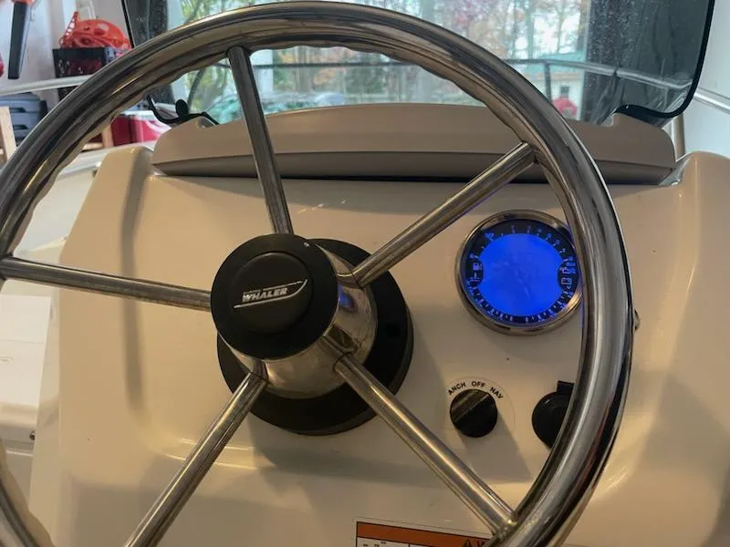Slide: The Image of Steering wheel and dashboard of 2020 Boston Whaler 130 Super Sport boat. - 2