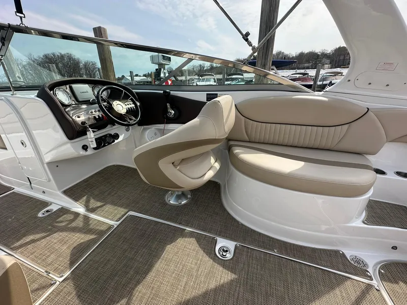 Slide: The Image of 2014 Cruisers Sport Series 278 Bow Rider interior with beige seating and modern dashboard. - 10