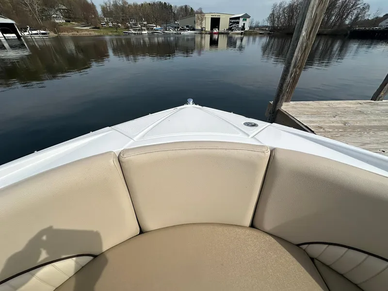 Slide: The Image of 2014 Cruisers Sport Series 278 Bow Rider at dock, calm water, beige seating. - 16