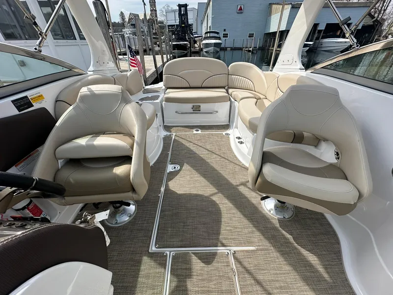 Slide: The Image of 2014 Cruisers Sport Series 278 Bow Rider interior with beige seating and spacious layout. - 19