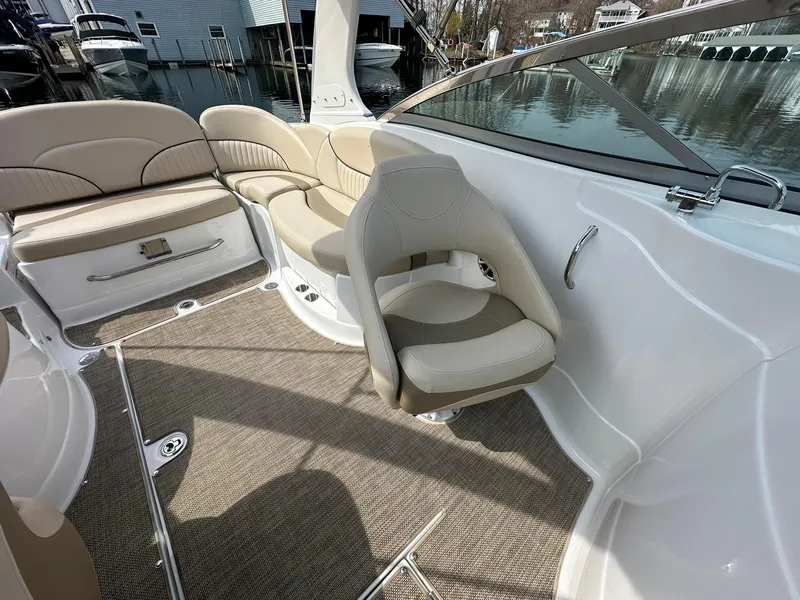 Slide: The Image of 2014 Cruisers Sport Series 278 Bow Rider interior with beige seating and carpeted flooring. - 21
