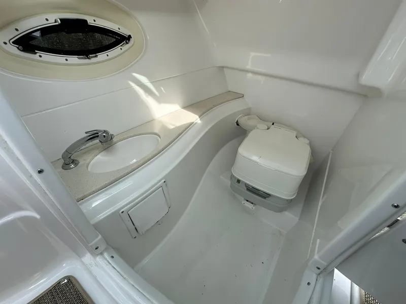 Slide: The Image of 2014 Cruisers Sport Series 278 Bow Rider bathroom with sink and toilet. - 24