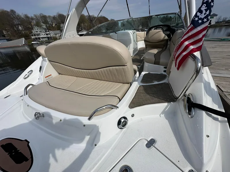 Slide: The Image of 2014 Cruisers Sport Series 278 Bow Rider with beige seating and American flag on a dock. - 7