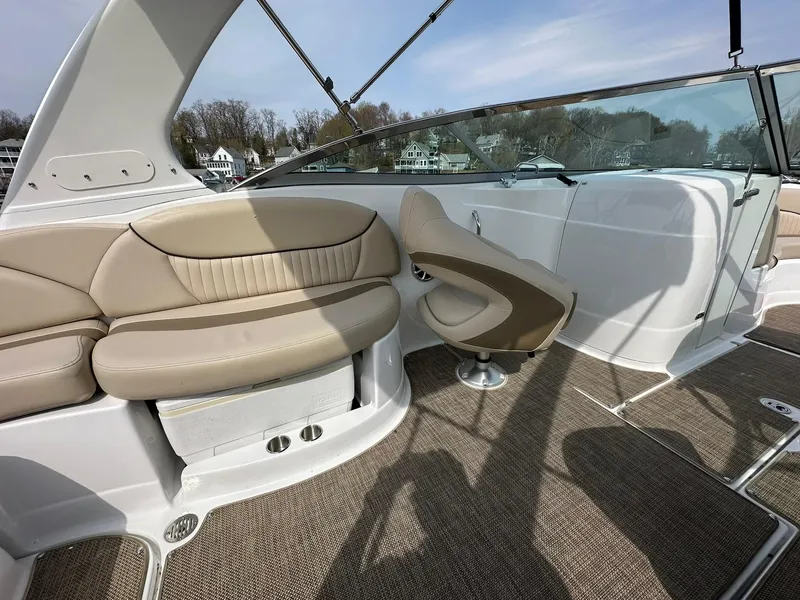 Slide: The Image of 2014 Cruisers Sport Series 278 Bow Rider interior with beige seating and carpeted flooring. - 9