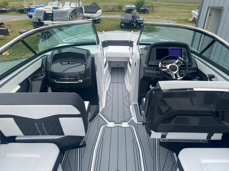 Slide: The Image of 2025 Monterey 278 Super Sport boat interior with sleek black and white seating and modern dashboard. - 13