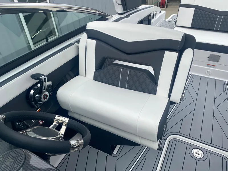 Slide: The Image of 2025 Monterey 278 Super Sport boat interior with sleek seating and modern steering wheel design. - 23