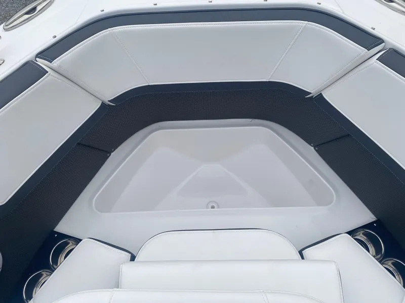 Slide: The Image of 2025 Monterey 278 Super Sport boat interior with white cushioned seating and cup holders. - 30