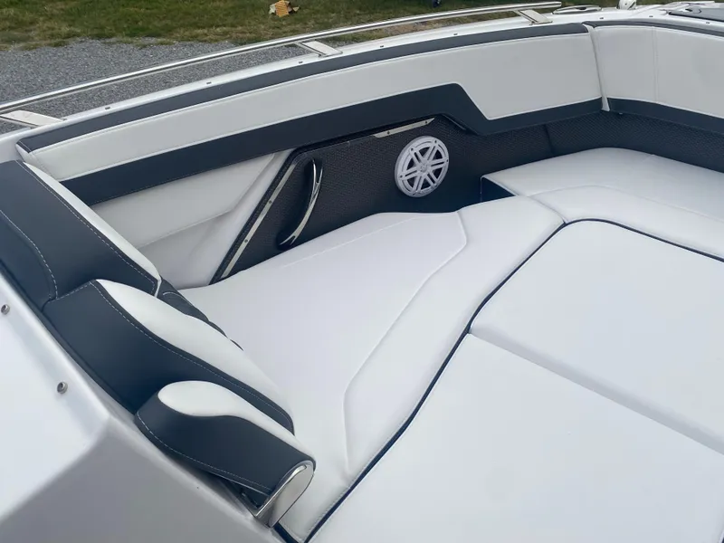 Slide: The Image of 2025 Monterey 278 Super Sport boat interior with white cushioned seating and speaker. - 31