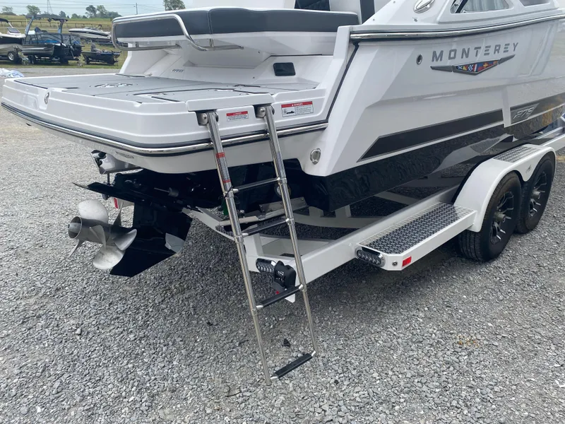 Slide: The Image of 2025 Monterey 278 Super Sport boat on trailer, featuring swim platform and ladder. - 5