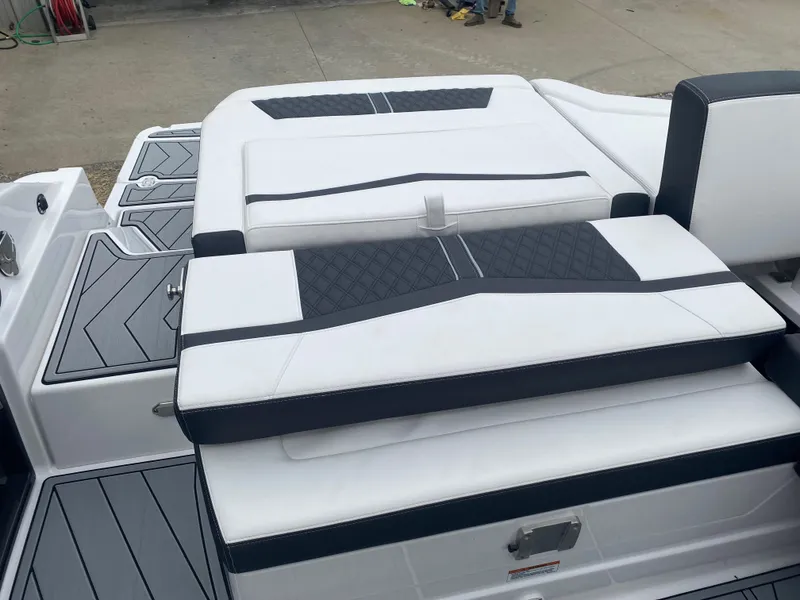 Slide: The Image of 2025 Monterey 278 Super Sport boat with sleek white and black seating design. - 9