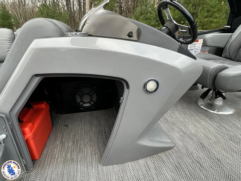 Slide: The Image of 2020 Bennington R 25 RSBA boat console with storage and speaker, featuring gray upholstery. - 10