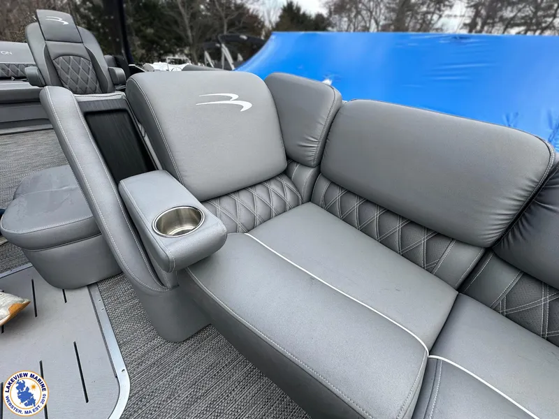 Slide: The Image of 2020 Bennington R 25 RSBA boat interior with gray cushioned seating and cup holder. - 6