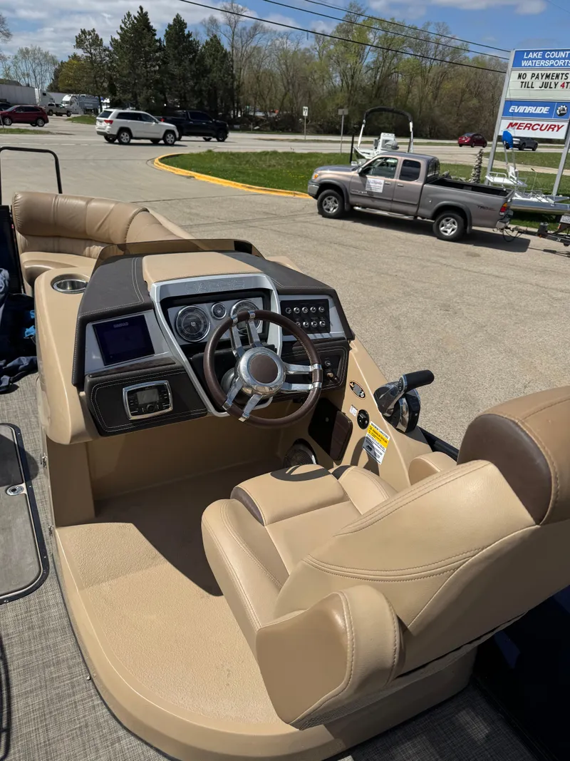 Slide: The Image of 2018 Harris Grand Mariner 230 boat interior with beige seating and modern dashboard. - 10