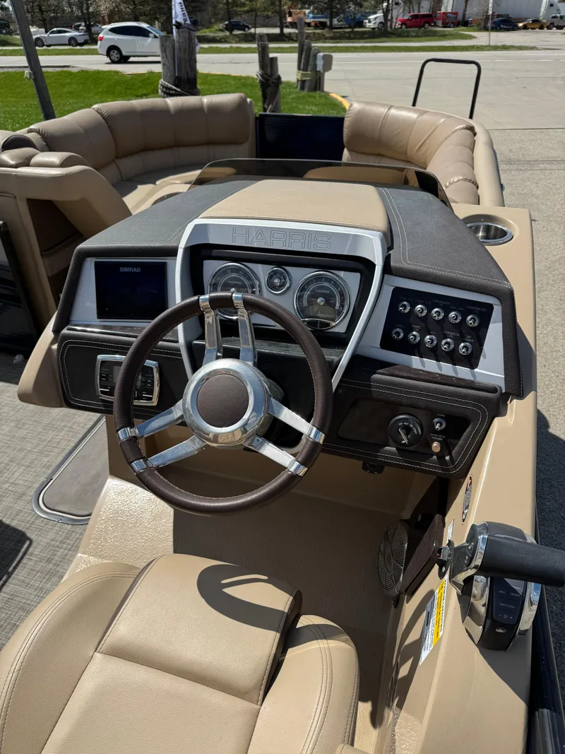 Slide: The Image of 2018 Harris Grand Mariner 230 boat dashboard with steering wheel and control panel. - 11