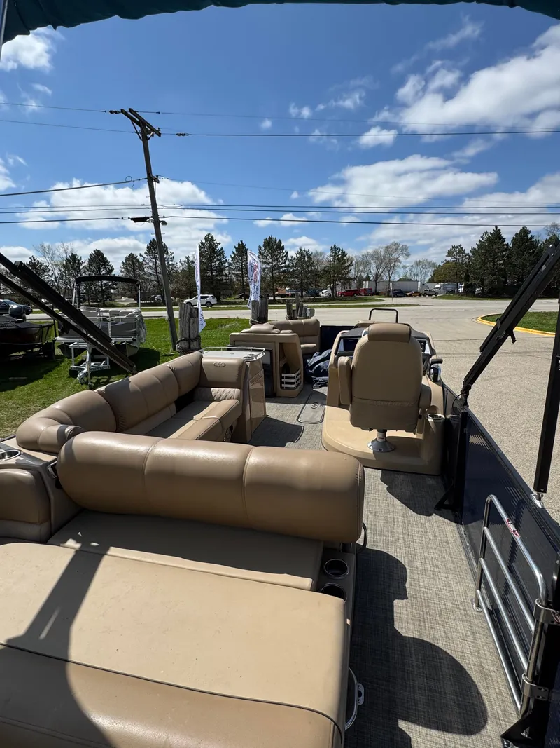 Slide: The Image of 2018 Harris Grand Mariner 230 pontoon boat with beige seating, under a clear blue sky. - 12