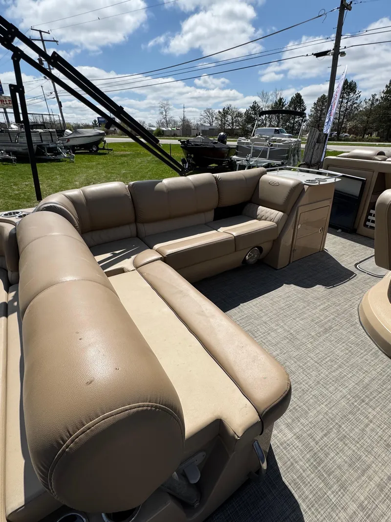 Slide: The Image of 2018 Harris Grand Mariner 230 pontoon boat with beige seating and outdoor setting. - 14