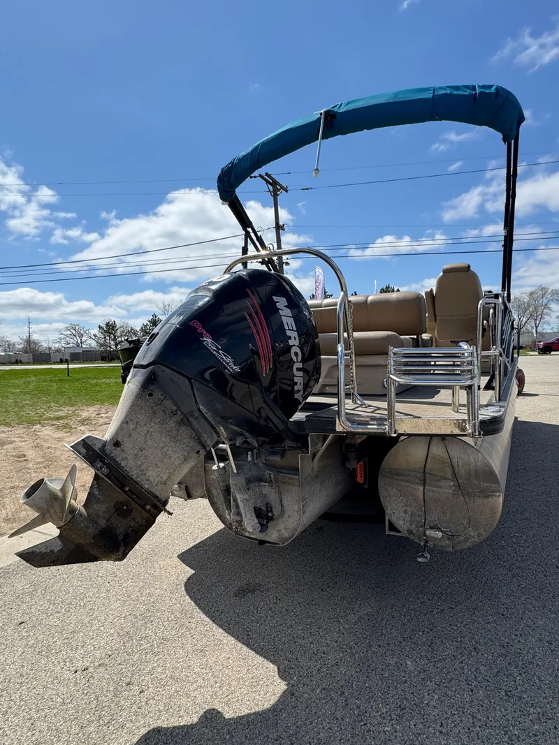 Slide: The Image of 2018 Harris Grand Mariner 230 pontoon boat with Mercury outboard motor, parked on pavement. - 3