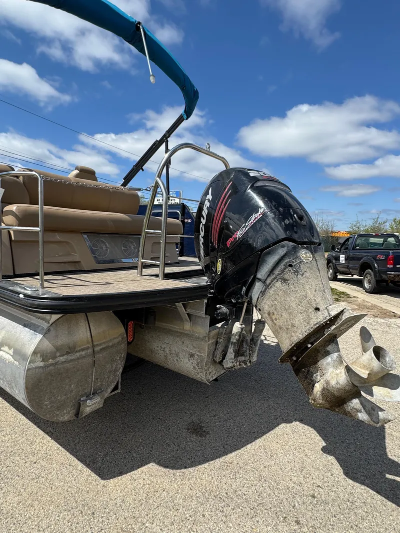 Slide: The Image of 2018 Harris Grand Mariner 230 pontoon boat with outboard motor, parked on a sunny day. - 4