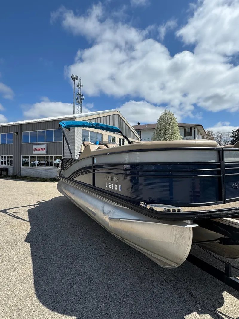 Slide: The Image of 2018 Harris Grand Mariner 230 pontoon boat parked outdoors under a blue sky. - 7